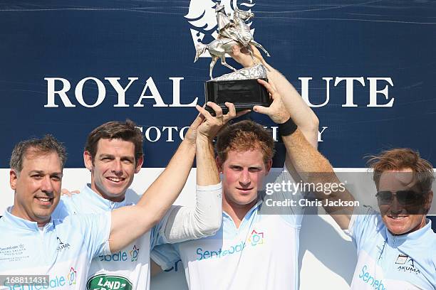 Prince Harry poses with trophy and Marc Ganzi, Malcom Borwick and Michael A. Carrazza of team Sentebale Land Rover at the Greenwich Polo Club during...