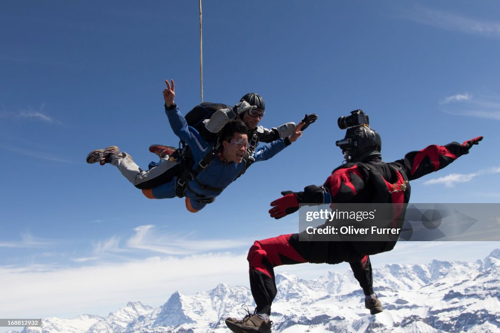 Sky divers diving in tandem over the Swiss Alps