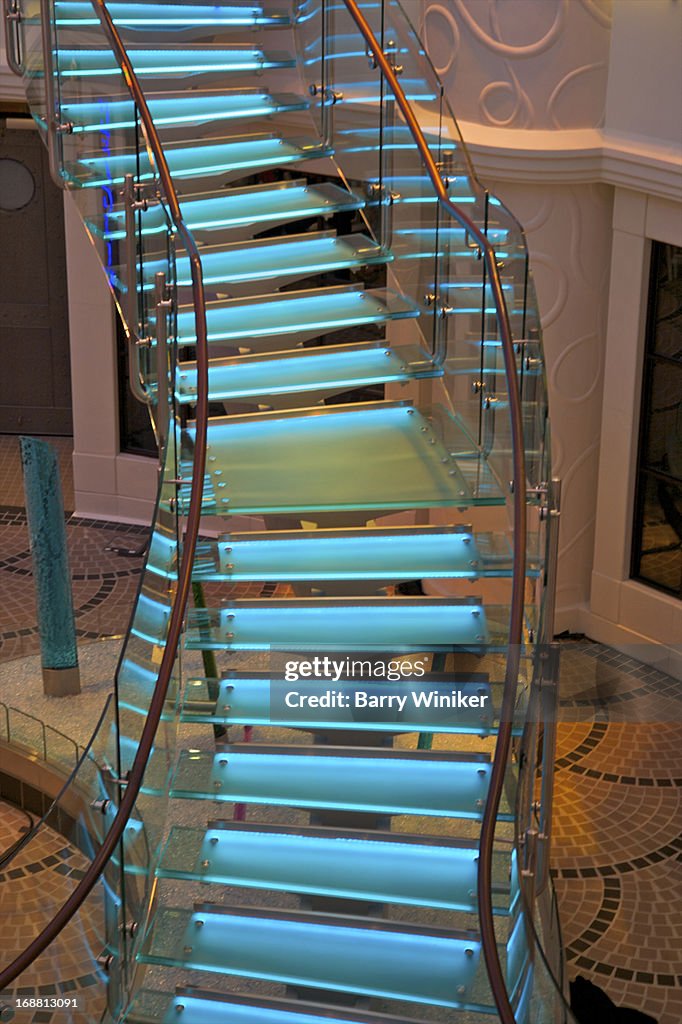 Blue-lit free-form staircase.
