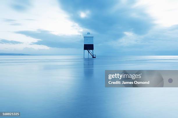 wooden lighthouse in the sea at dusk - burnham on sea stock pictures, royalty-free photos & images