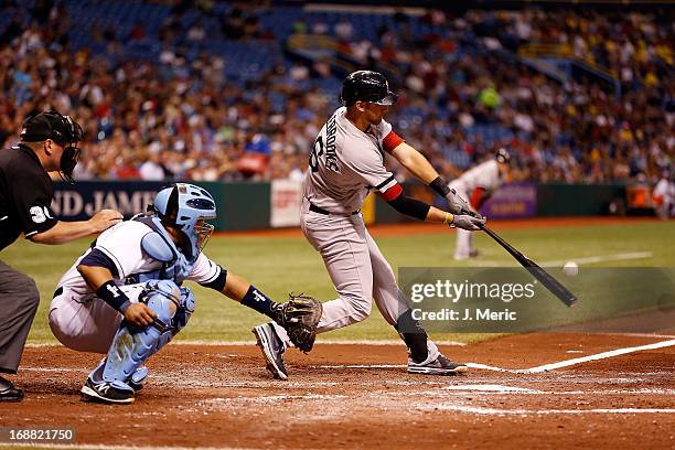 Infielder Will Middlebrooks of the Boston Red Sox fouls off a pitch against the Tampa Bay Rays during the game at Tropicana Field on May 15, 2013 in...