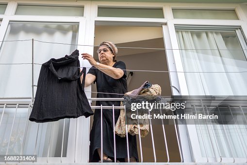 Woman hanging old tiled facades