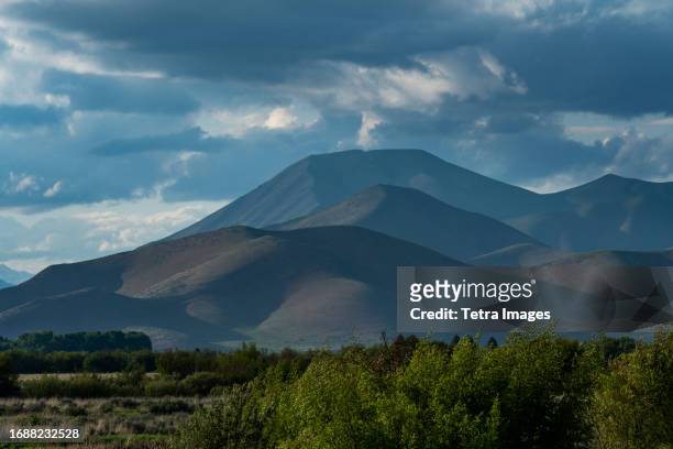 usa, idaho, bellevue, clouds above mountains at sunset - sun valley idaho stock pictures, royalty-free photos & images