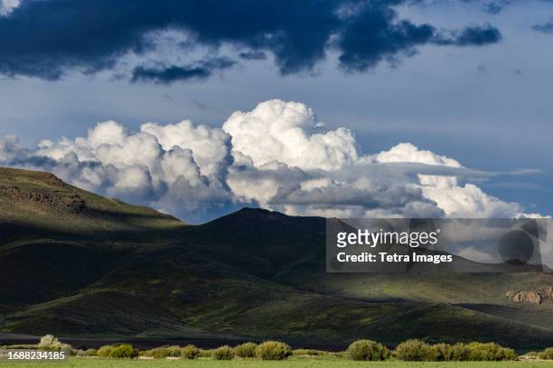 usa, idaho, bellevue, majestic cumulus clouds above mountains - sun valley idaho stock pictures, royalty-free photos & images