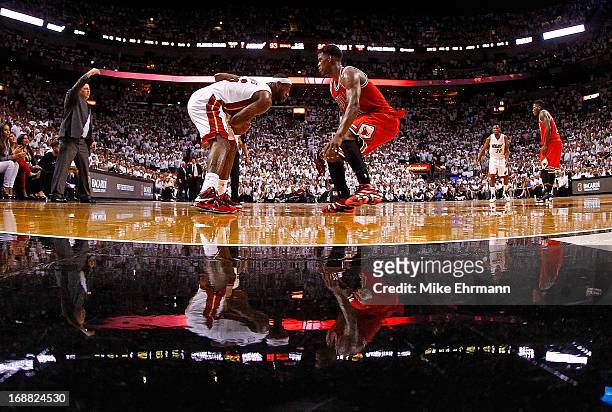 LeBron James of the Miami Heat is guarded by Jimmy Butler of the Chicago Bulls during Game Five of the Eastern Conference Semifinals of the 2013 NBA...