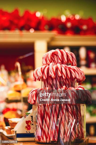 many candy canes for sale in a shop setting at christmas time - lollipops stock pictures, royalty-free photos & images