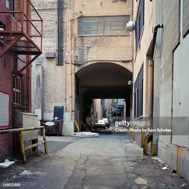 dirty back alleyway downtown - sam day stockfoto's en -beelden