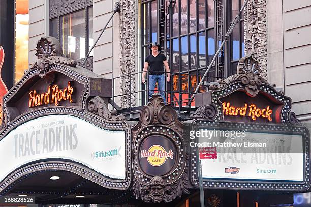 Musician Trace Adkins stands on the Hard Rock Cafe's marquee during "SirusXM Sounds Of Summer" Series at Hard Rock Cafe New York on May 15, 2013 in...