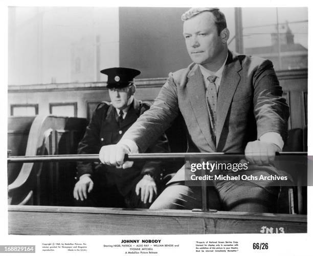 Aldo Ray sits in a jury box in a scene from the film 'Johnny Nobody', 1961.