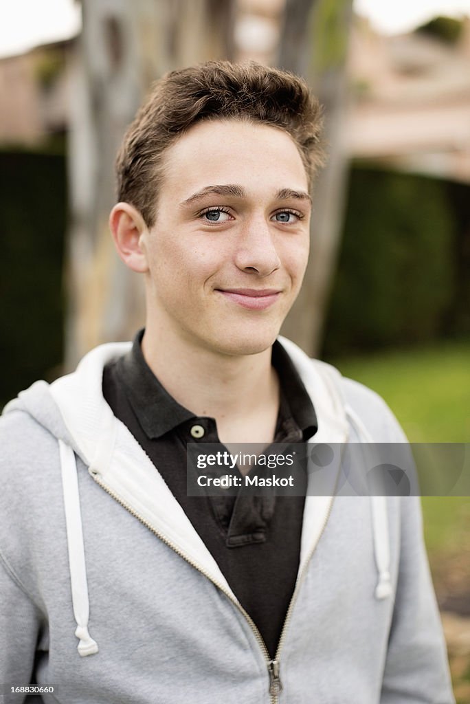 Portrait of young boy wearing hooded shirt