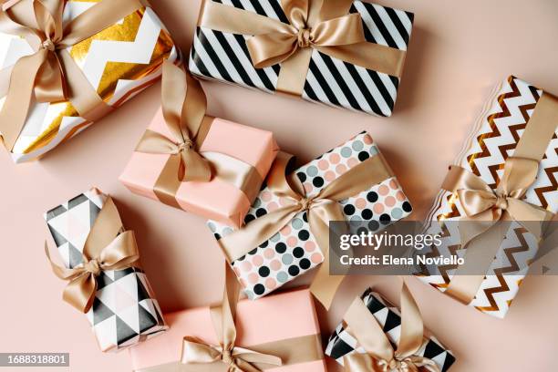 festive christmas new year background colorful gift boxes and holiday decorations on beige background. new year's present and christmas present top view - wrapping paper stock pictures, royalty-free photos & images