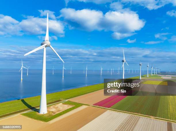 wind turbines on a levee and offshore during springtime seen from above - ijsselmeer stock pictures, royalty-free photos & images