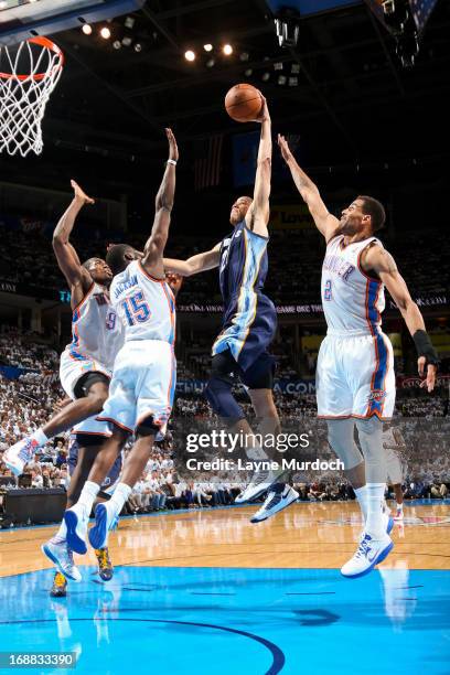 Tayshaun Prince of the Memphis Grizzlies rises for a dunk against Serge Ibaka, Reggie Jackson and Thabo Sefolosha of the Oklahoma City Thunder in...