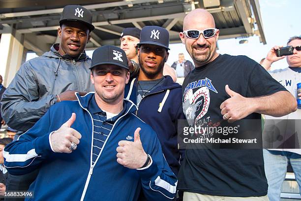New York Giants players David Wilson, Bear Pascoe, Rueben Randle with 'Bald' Vinny Milano attend the Seattle Mariners vs New York Yankees game at...