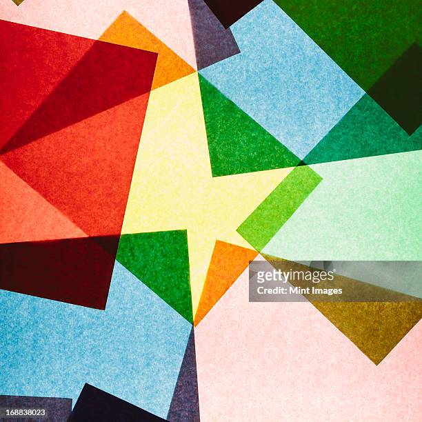 multi-colored pieces of recycled construction paper. shapes, triangles and different colours, above a light source. - quadrato composizione foto e immagini stock