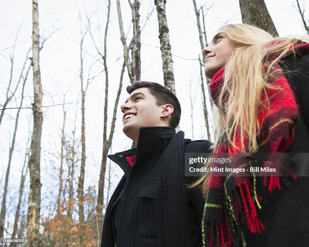 A couple in winter coats outdoors on a winter's day.