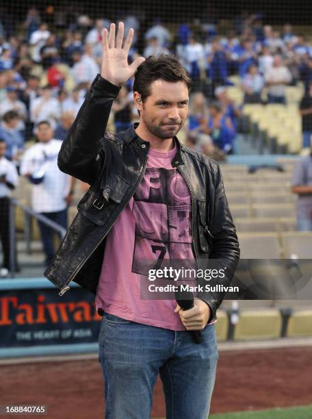 Singer Michael Johns sings the national anthem before the MLB game between the Los Angeles Dodgers and Washington Nationals at Dodger Stadium on May...