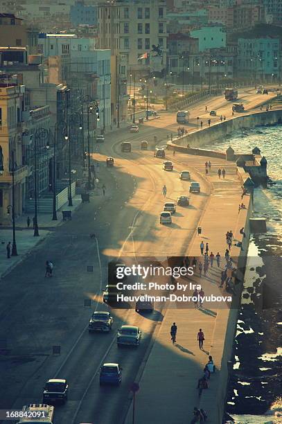 walking on malecon in havana, cuba. - havana stock pictures, royalty-free photos & images