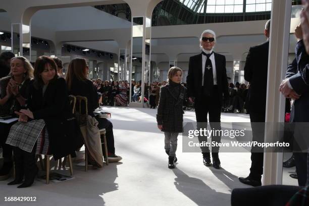 Designer Karl Lagerfeld walks the runway with godson Hudson Kroenig at the Chanel show during Paris Fashion Week Autumn/Winter 2016/17, Hudson wears...
