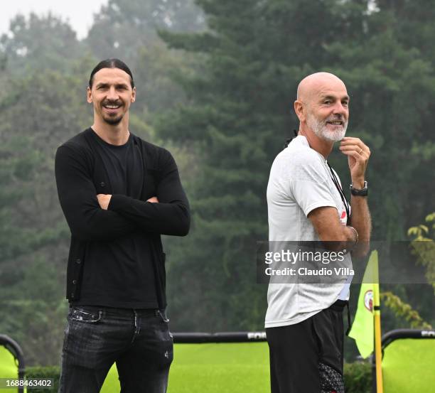 Head coach Stefano Pioli of AC Milan and Zlatan Ibrahimovic attend an AC Milan training session at Milanello on September 18, 2023 in Cairate, Italy.