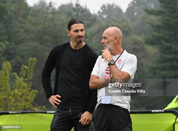 Head coach Stefano Pioli of AC Milan and Zlatan Ibrahimovic attend an AC Milan training session at Milanello on September 18, 2023 in Cairate, Italy.