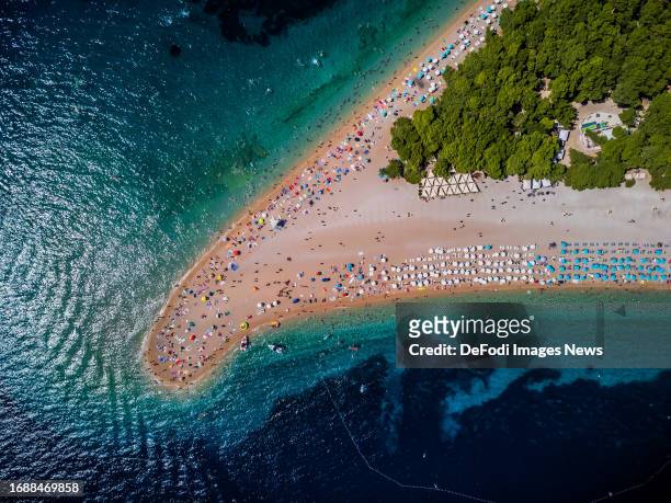 Tourists are seen on a beach known as Zlatni rat near Bol at the Croatian Adriatic island of Brac, 450 km southeast from the capital Zagreb on August...