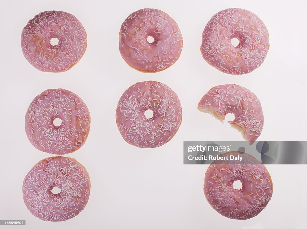 Sequence of bites taken from pink donut