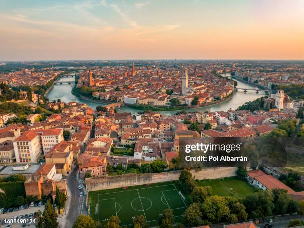 verona italy skyline, aerial view of historical city centre, ponte pietra bridge across adige river, cathedral, duomo, red tiled roofs, veneto region - verona italy stock pictures, royalty-free photos & images