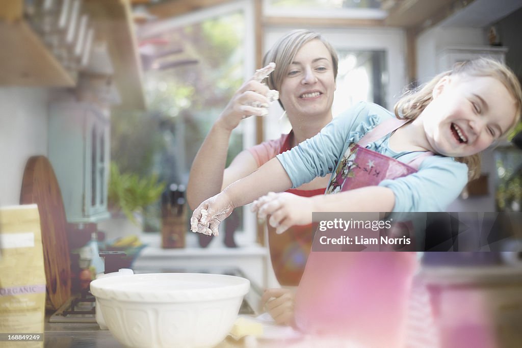 Mother and daughter baking together