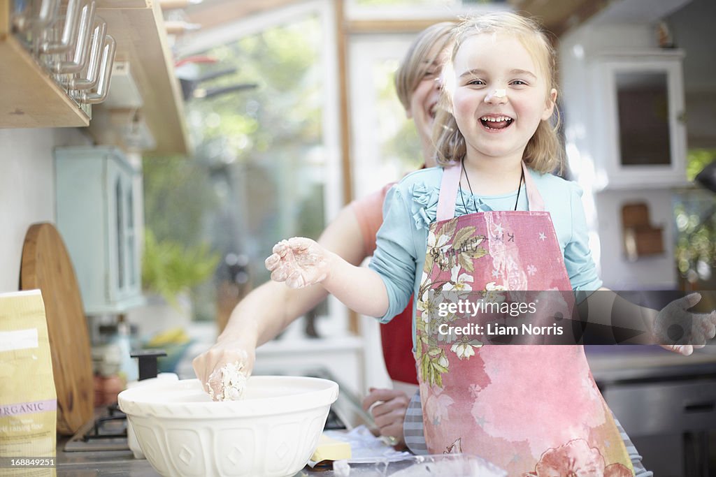 Mother and daughter baking together