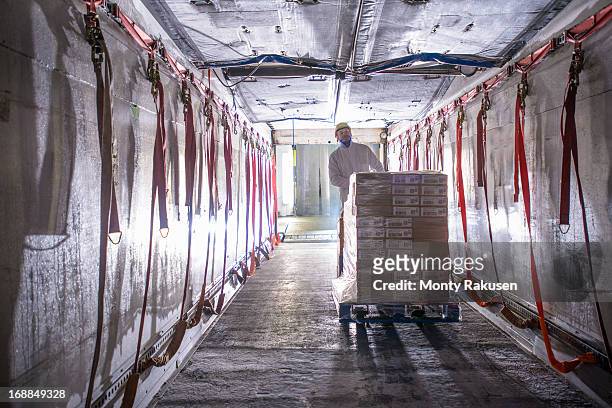 worker loading products into freezer truck of food factory - pallet industrial equipment fotografías e imágenes de stock