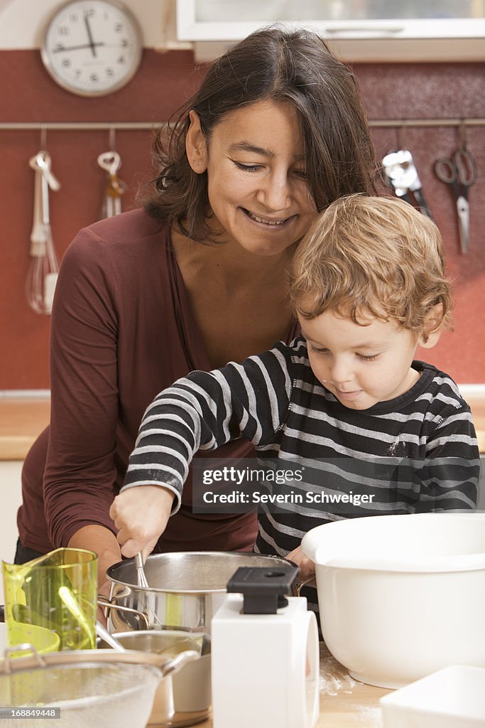 Mother and son cooking in kitchen