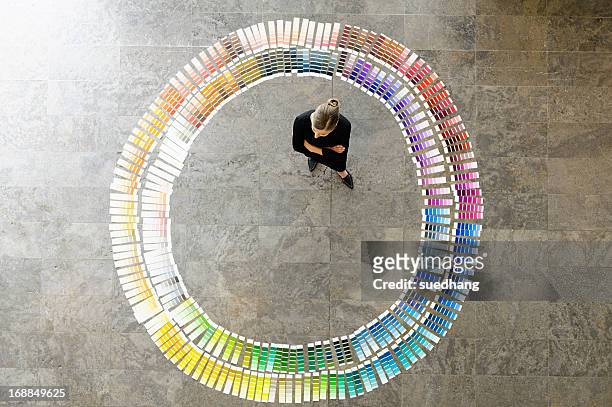 businesswoman examining paint swatches - color chart stock-fotos und bilder