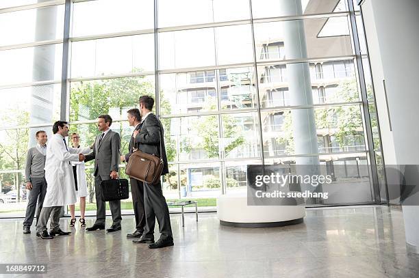 doctors and businessmen meeting - medical lobby stock pictures, royalty-free photos & images