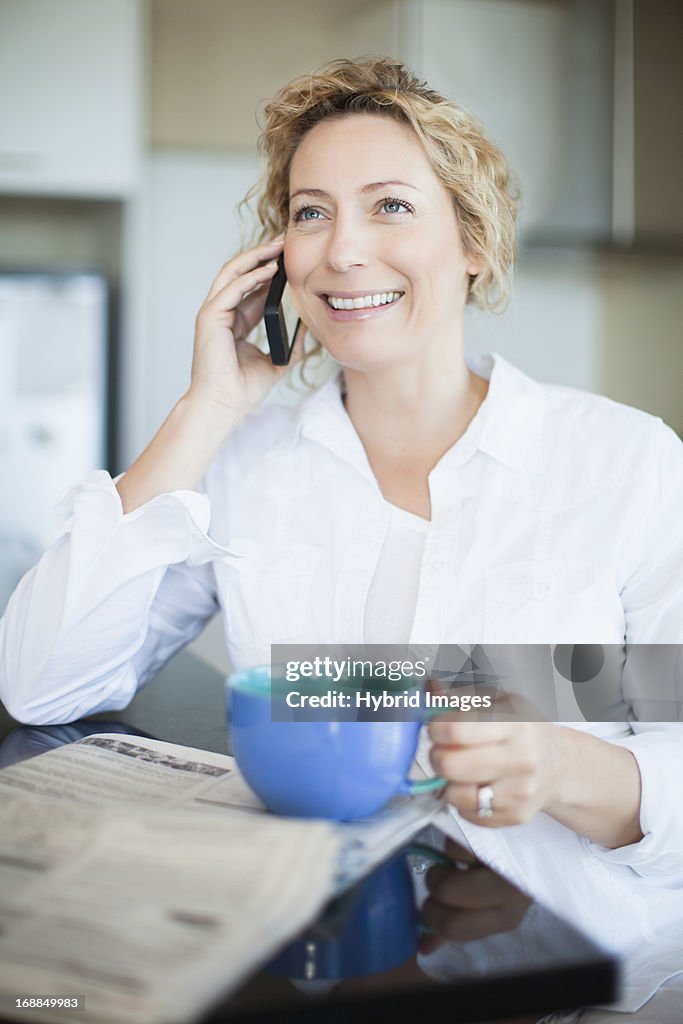 Woman with coffee talking on phone