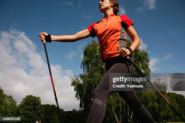 woman hiking in park - walker stock-fotos und bilder