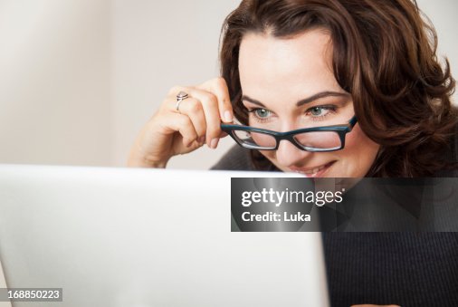 Businesswoman using laptop at desk Businesswoman using laptop at desk