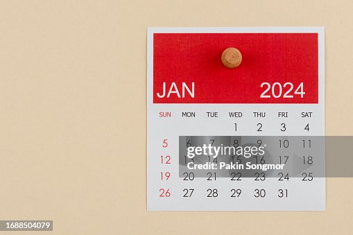 Desk Calendar 2024: January calendar is used to plan daily work and life with a push pin on a beige color paper background.