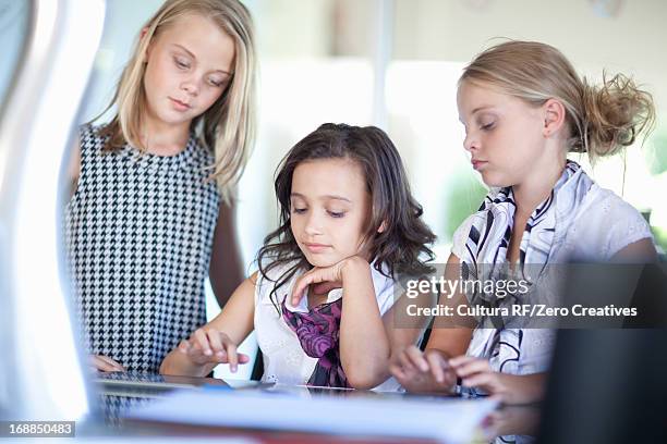 girls playing businesswomen at desk - rf business stock pictures, royalty-free photos & images