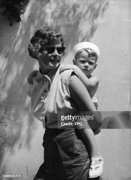 Swedish actress Ingrid Bergman giving her son, Robin, a piggyback while on holiday in Portofino in the Tigullio Gulf, Liguria, Italy, 13th August...