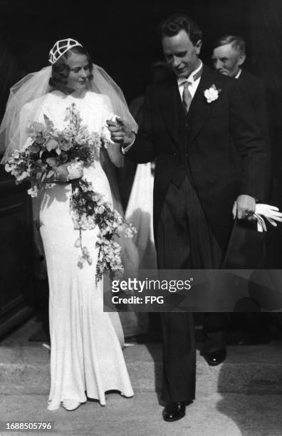 Swedish actress Ingrid Bergman, wearing a crepe floor-length gown with a caged Juliet cap and veil, and Swedish dental surgeon Petter Lindstrom on...
