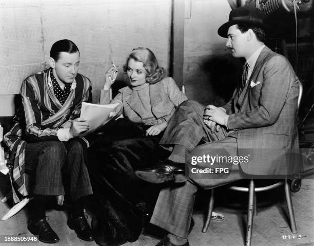 British actor Herbert Marshall, holding a script, American actress Constance Bennett, holding a lit cigarette, and British actor Hugh Williams during...