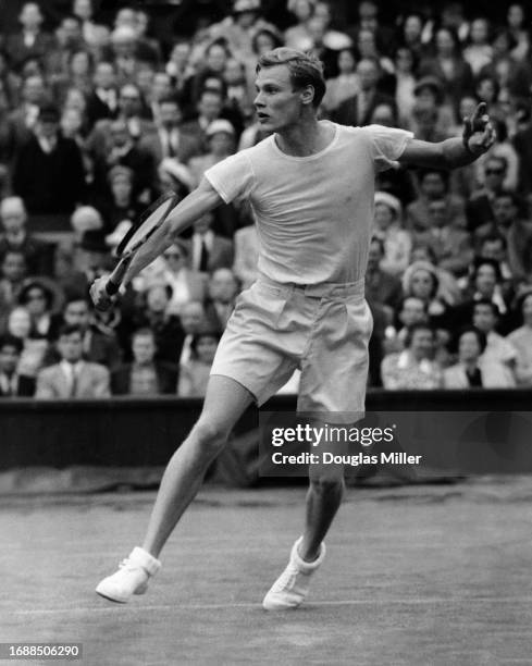 Swedish tennis player Lennart Bergelin in action during his second round match of the Men's Singles competition at the 1950 Wimbledon Championships,...