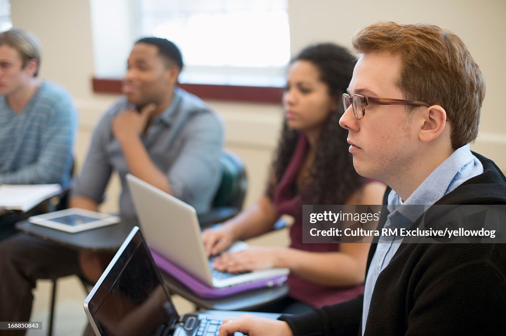 Students using laptops in class