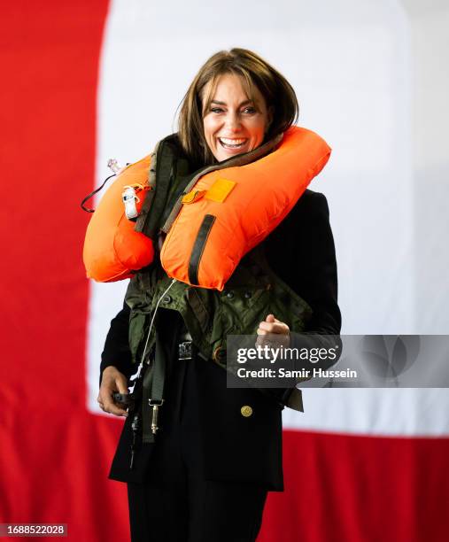 Catherine, Princess of Wales tries on a life jacket during her visit to Royal Naval Air Station Yeovilton on September 18, 2023 in Yeovil, England....