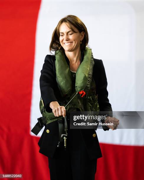 Catherine, Princess of Wales tries on a life jacket during her visit to Royal Naval Air Station Yeovilton on September 18, 2023 in Yeovil, England....