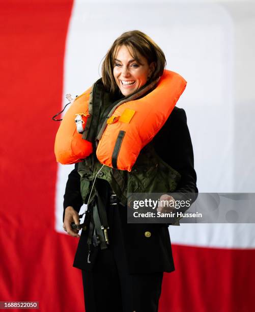 Catherine, Princess of Wales tries on a life jacket during her visit to Royal Naval Air Station Yeovilton on September 18, 2023 in Yeovil, England....