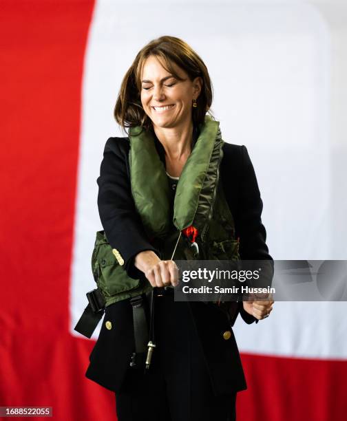 Catherine, Princess of Wales tries on a life jacket during her visit to Royal Naval Air Station Yeovilton on September 18, 2023 in Yeovil, England....