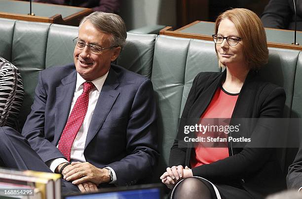 Treasurer Wayne Swan and Prime Minister Julia Gillard listen to Opposition leader, Tony Abbott delivering his budget reply in the House of...