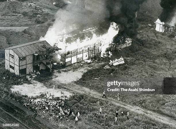 In this aerial image, extreme left wing students who support the protest of new airport construction set fire to the construction workers' residence...